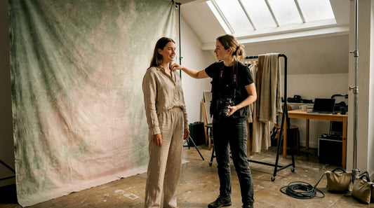 Fashion photographer adjusting model in studio